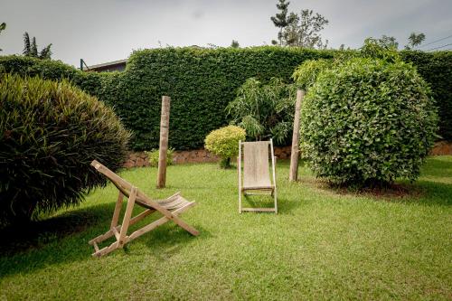 a chair and a sign sitting in the grass at Inkindi House in Kigali