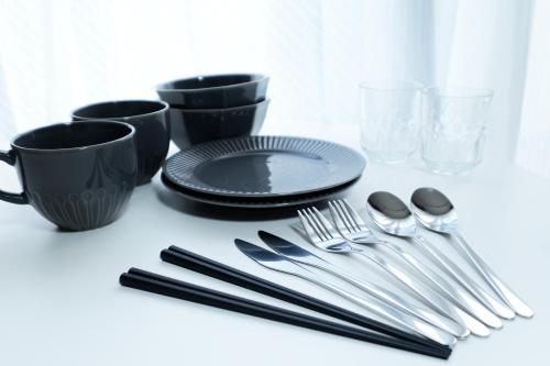 a table with a plate and cutlery on it at Ruygo Setagaya by Tranova in Tokyo