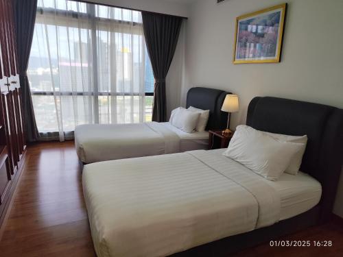 Postel nebo postele na pokoji v ubytování Citypluse Suites at Times Square Kuala Lumpur