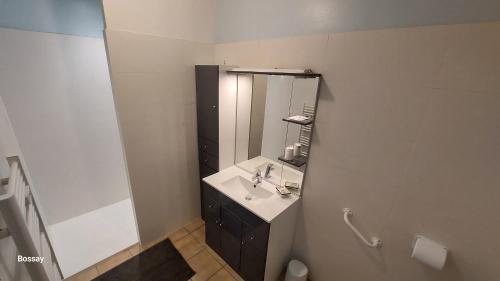 a bathroom with a sink and a mirror at L'insulaire Studios in Saint-Denis-dʼOléron