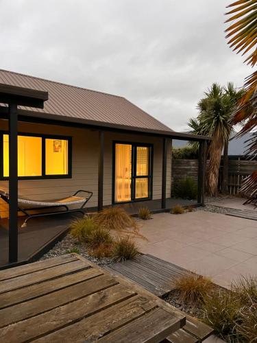 a house with a hammock in front of it at A family friendly haven in Hanmer Springs