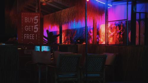 a group of chairs in front of a stage with red and blue lights at Noahs Ark in Amphoe Koh Samui