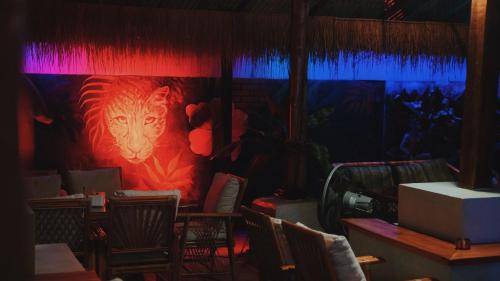 a room with a painting of a tiger on the wall at Noahs Ark in Amphoe Koh Samui