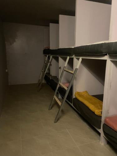 a room with two bunk beds and a ladder at Noahs Ark in Amphoe Koh Samui