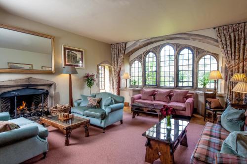 a living room filled with furniture and a fireplace at Amberley Castle- A Relais & Chateaux Hotel in Amberley