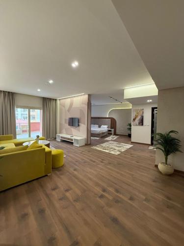 a large living room with a yellow couch and a living room at Tolip Family Park Hotel in Cairo