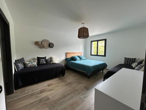 a living room with a bed and a couch at Villa la crozette 4 étoiles, climatisée avec grande piscine in Ruoms