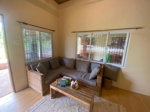 a living room with a couch and a table at EcoSiquijor Haven in San Juan