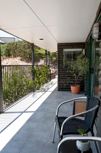 a patio with two chairs and a table on a building at Casa Salvador in Flagstaff Hill