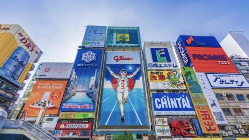 a group of buildings with signs on them at Hotel Arashi Nambaminami No003 in Osaka