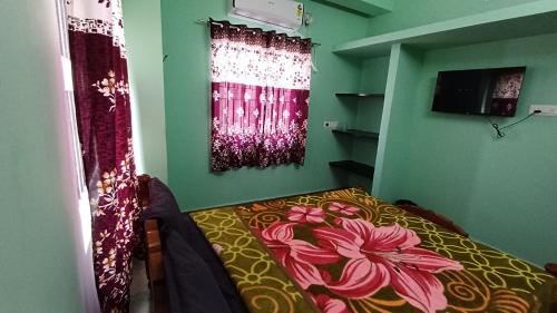 a bedroom with a bed with a flower painted on it at WHITRS INN KILAMBAKKAm in Chennai