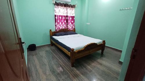 a small bed in a room with a window at WHITRS INN KILAMBAKKAm in Chennai