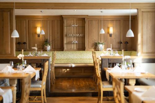 a dining room with wooden tables and chairs at Romantikhotel Platte in Attendorn