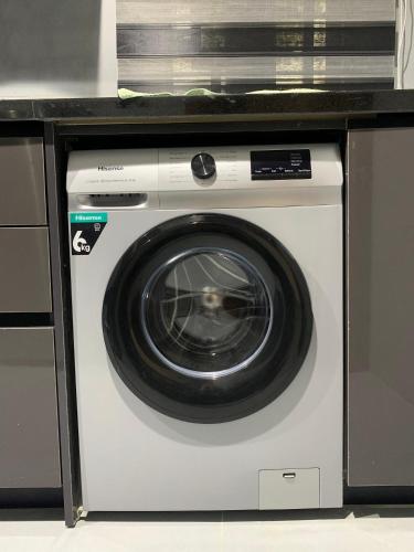 a white washing machine with a counter on top of it at Accommodation Guru in Abuja