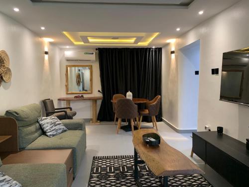 a living room with a couch and a table at Accommodation Guru in Abuja