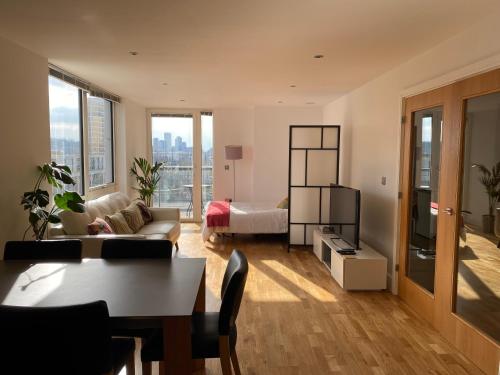 a living room with a couch and a bed at River view spacious apartment in London