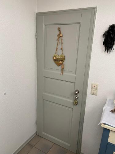a white door with a purse hanging on it at Im Salzgässle in Schonach