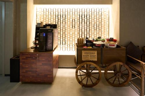 a cart with a coffee maker on top of a table at Hotel Resol Nagoya in Nagoya