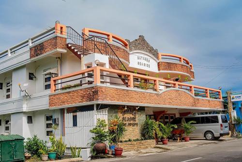 a building with a balcony on the side of it at Batanes Seaside Lodge & Restaurant in Basco