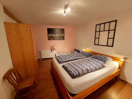 a bedroom with a bed and a chair in it at HAUS BRAILEN in Brilon Alme in Brilon