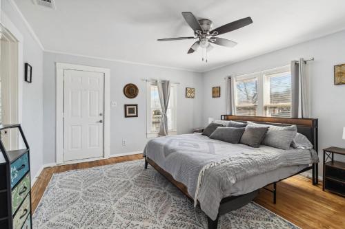 a bedroom with a bed and a ceiling fan at Charming Bungalow in McKinney – Walk to Downtown bungalow in McKinney
