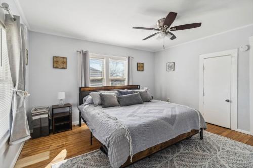 a bedroom with a bed and a ceiling fan at Charming Bungalow in McKinney – Walk to Downtown bungalow in McKinney
