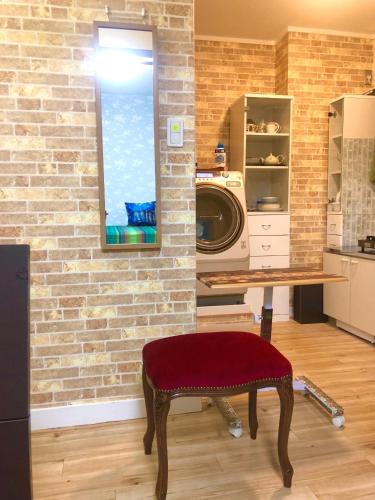 a room with a brick wall and a washer and dryer at BlueHouse in Hiroshima