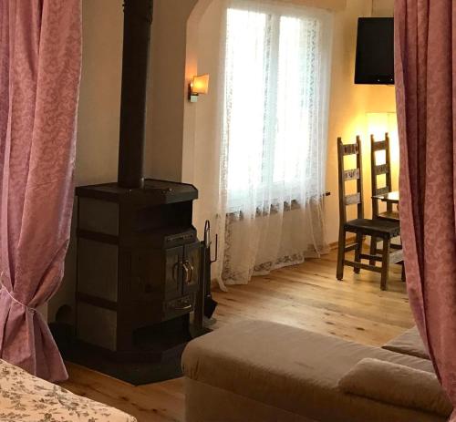 a living room with a wood stove in a room at Casa Ines in Gambarogno