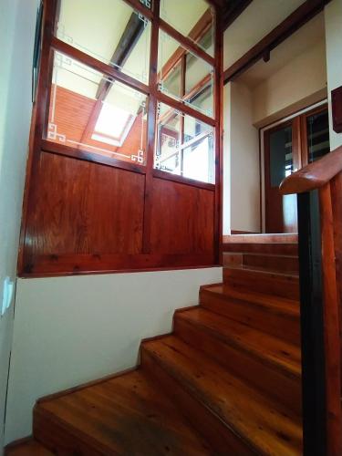 a room with a wooden door and stairs at Magyar Lovasvendégház in Szilvásvárad
