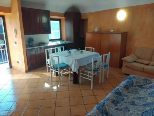 a kitchen and dining room with a table and chairs at Emma Lake Apartment lago di Viverone in Viverone