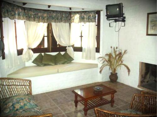 a living room with a couch and a window seat at Cabañas La Paloma in La Paloma