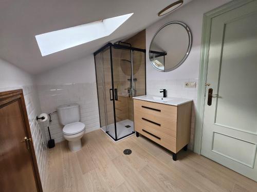 a bathroom with a shower and a toilet and a sink at El Tayo in Cudillero