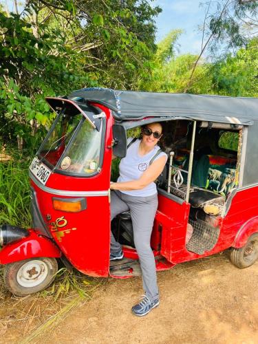 a woman sitting in the back of a small car at Wild Blossom Sigiriya in Sigiriya