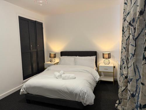 a bedroom with a bed with two towels on it at Stunning 4-Bed House in Bridgend in Bridgend