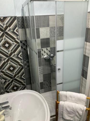 a bathroom with a sink and a shower at Eruption1669 in Catania