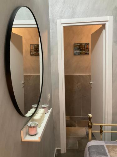 a bathroom with a large mirror and a shower at Eruption1669 in Catania