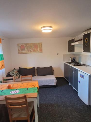 a small room with a couch and a table at Apartamencik Pod Krokusem 2 in Rabka