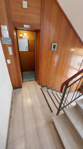 a hallway with a door and stairs in a building at Hotel Etrusco in Sesto Fiorentino