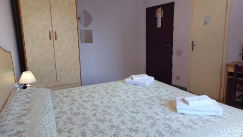 a bedroom with a bed with towels on it at Hotel Etrusco in Sesto Fiorentino