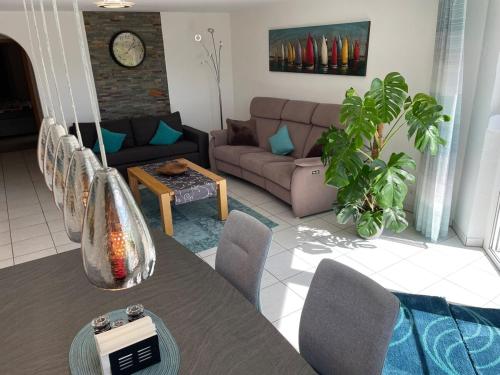 a living room with a couch and a table at Sonnige Südwohnung mit Terrasse, Badesee in Forchtenberg