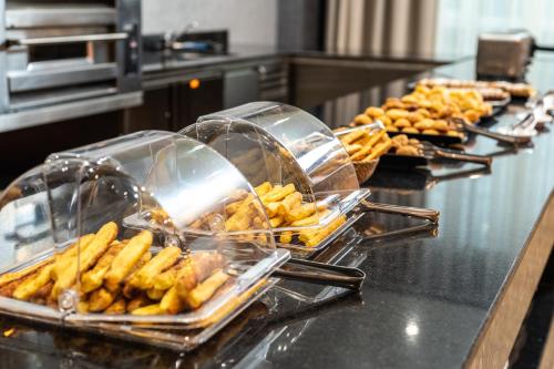 a buffet line with trays of food and pastries at Empire Balneo & Spa Hotel in Hisarya