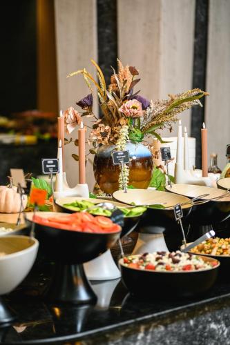 a buffet with plates of food on a table at Empire Balneo & Spa Hotel in Hisarya