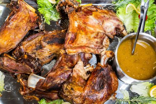 a plate of food with a turkey and dipping sauce at Empire Balneo & Spa Hotel in Hisarya
