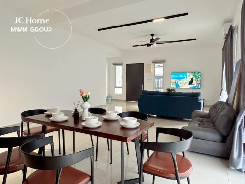 a dining room and living room with a table and chairs at Kluang Gunung Lambak view Family Suites in Kluang