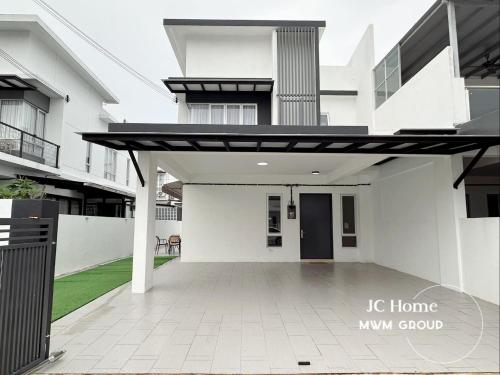 a large white building with awning in front of it at Kluang Gunung Lambak view Family Suites in Kluang