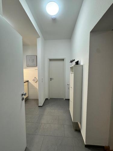 a room with a hallway with a door and a tile floor at MARKINA- Ferienwohnung "Am Park" in Mühlhausen