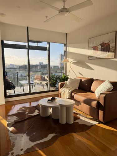a living room with a couch and a table at Luxury Stay With City View - Free Parking,Pool,Wifi in Brisbane