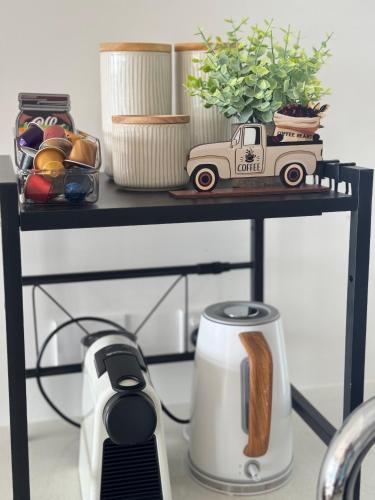a table with a coffee maker and a truck on it at Luxury Stay With City View - Free Parking,Pool,Wifi in Brisbane