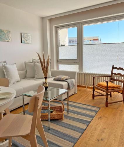 a living room with a couch and a table at Haus Grömitz Wohnung 15 in Grömitz