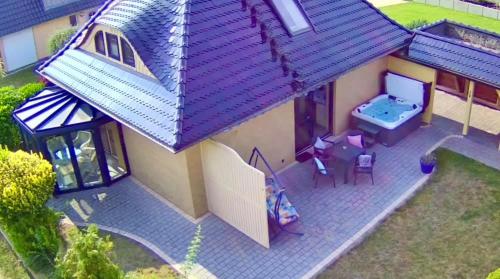 an overhead view of a small house with a tub at Villa am See in Göhren-Lebbin